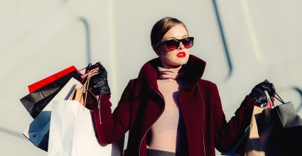 Model carrying branded shopping bags