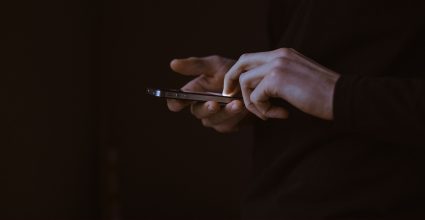 A person typing on a mobile phone 