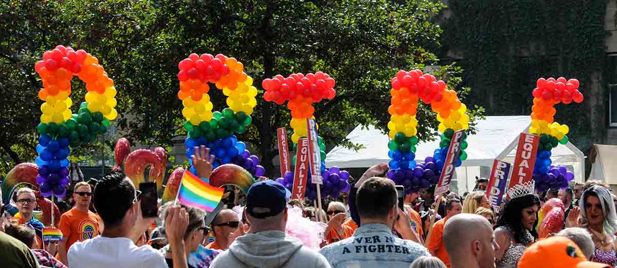 Balloons at a parade that spell the word "Pride"